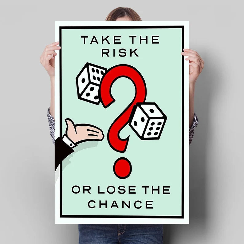 Person holding a large Monopoly style Take the Risk poster for size scale comparison